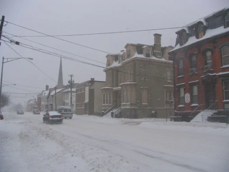 Winter storm in Poughkeepsie with snow accumulation and icy sidewalks.